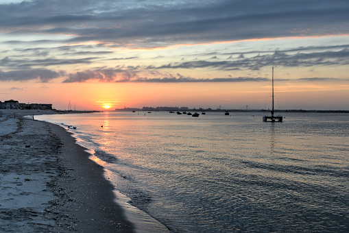 Sunset from the Rockaways, Queens, NY with Coney Island in the distance.