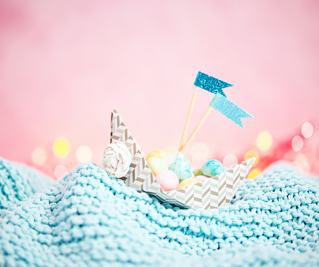Handmade origami boat filled with tiny Easter eggs  - props made by photographer