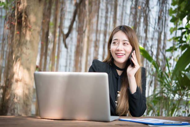 istock Young business woman talking on the phone while sitting at her working place. 928196192