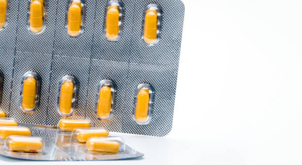 istock Orange capsule pills in blister pack isolated on white background with copy space for text. Antibiotics drug resistance and antimicrobial drug use with reasonable concept. Global healthcare. 928200722