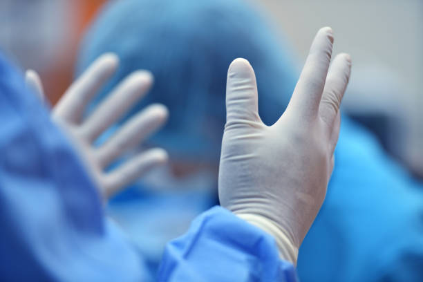 istock Surgeon hand putting on a grove and preparing for a surgery 928202624