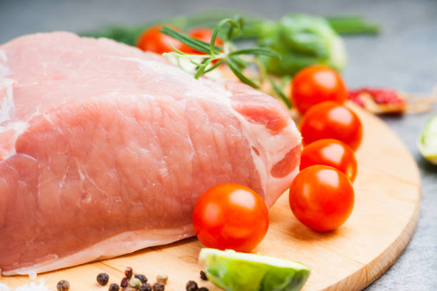 istock Raw pork on cutting board and vegetables 928202984