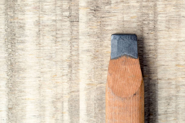 istock Used wooden pencil isolated on wooden table. 928209330