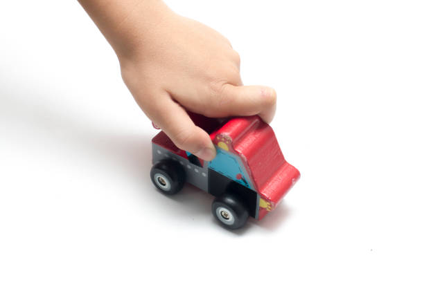 istock child playing a wooden toy car. 928212628