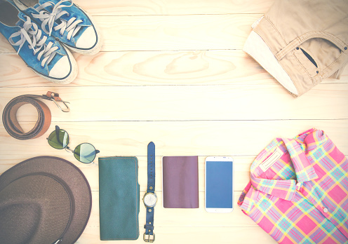 Casual clothing and accessories on the wooden background.