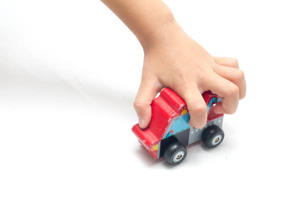 istock child playing a wooden toy car. 928214210