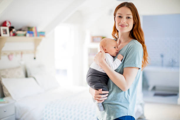 istock Smiling mother embracing newborn son at home 928214688
