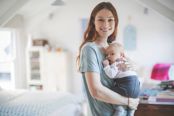 istock Smiling mother embracing newborn son at home 928214702