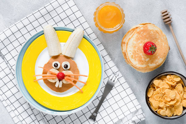 istock Breakfast for kids. Easter Bunny pancake, honey and cornflakes 928217726