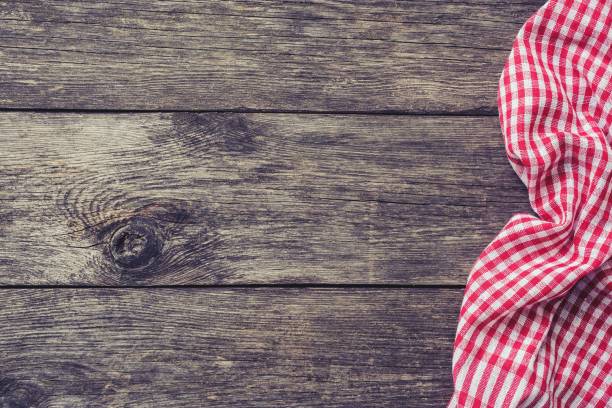 istock Red kitchen textile on rustic wood. Picnic summer background 928217778