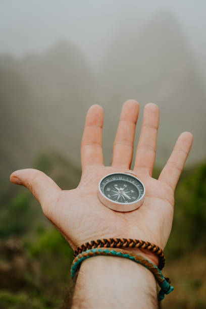 istock Hand with compass in the misty mountain terrain 928217950