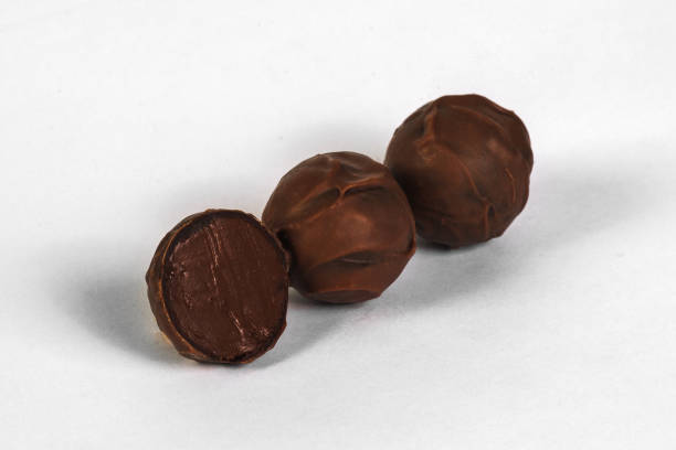 istock Cut handmade chocolate candy with  filling isolated on white 928221522