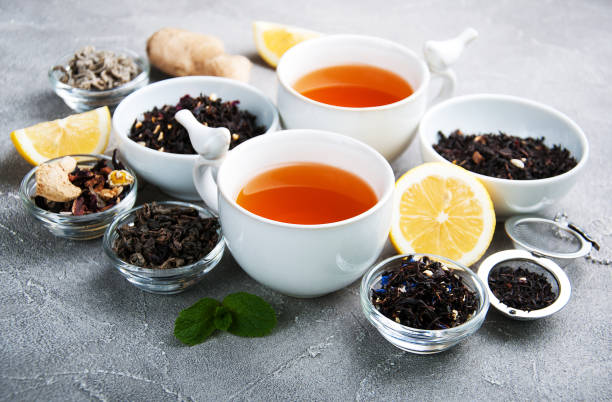 istock Cups of tea with aromatic dry tea in bowls 928222314