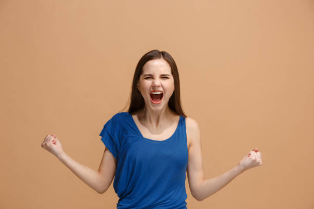 istock Winning success woman happy ecstatic celebrating being a winner. Dynamic energetic image of female model 928222430