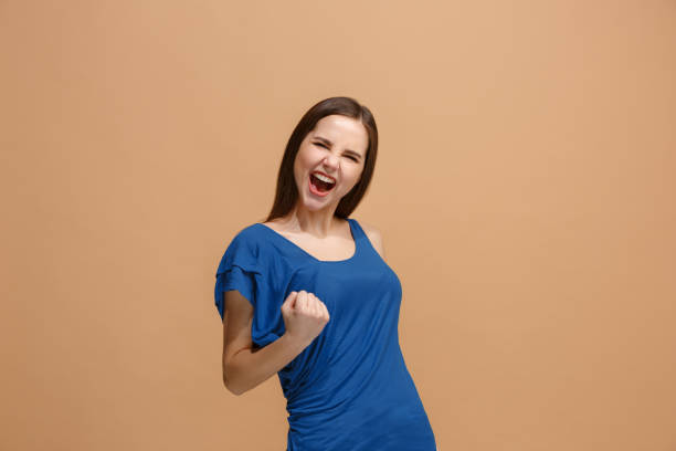 Winning success woman happy ecstatic celebrating being a winner. Dynamic energetic image of female model