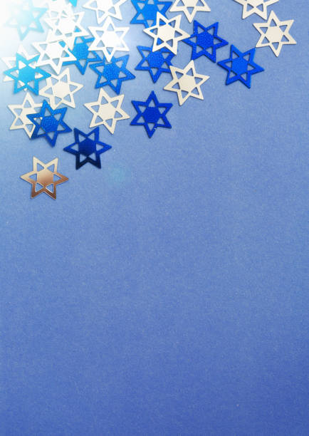 istock Shiny star-shaped confetti on shaded blue background 928223208