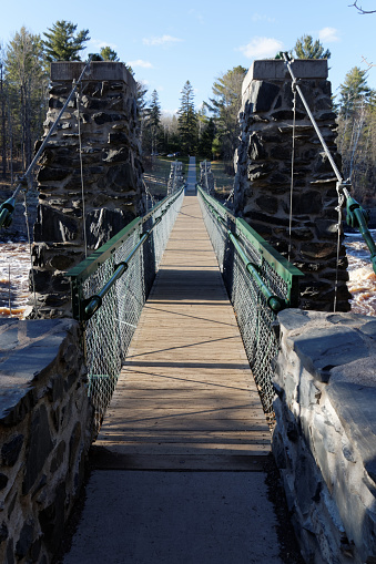 Jay Cooke State Park, MN/USA - April 21, 2017: The entrance to the rebuilt Swinging Bridge over the St. Louis River in Jay Cooke State Park in Minnesota.