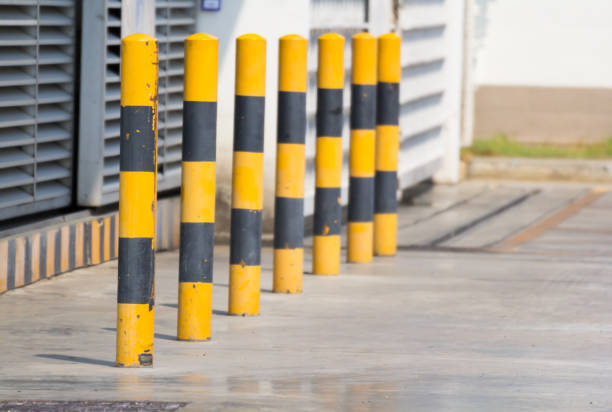 istock yellow and black steel bollards on concrete floor 928223384