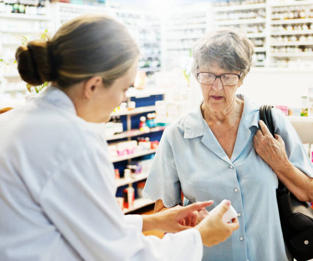 istock Female pharmacist explaining medication to senior woman customer 928235076