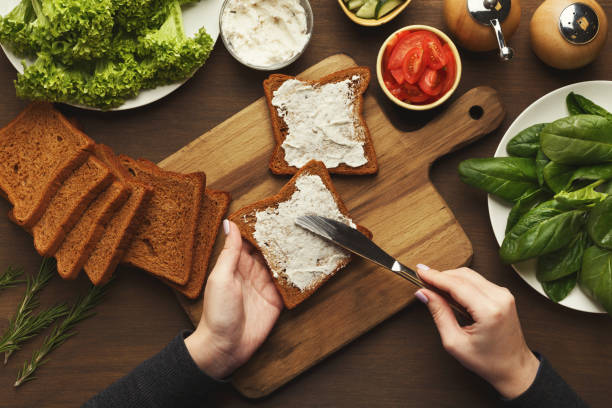 istock Top view on female hands making vegetable bruschettas 928235096