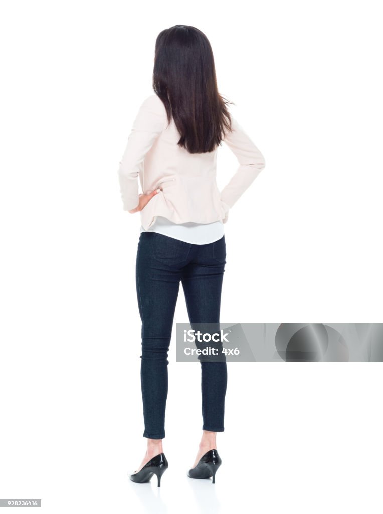 Attractive young businesswoman with hands on hips Attractive young lady Rear View Stock Photo
