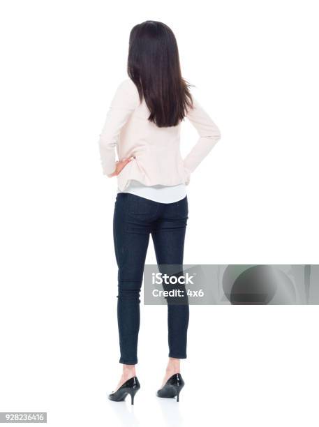 Attractive Young Businesswoman With Hands On Hips Stock Photo - Download Image Now - Rear View, Women, One Woman Only
