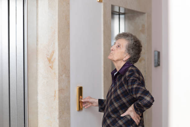 istock Old woman is waiting for a lift. 928240304