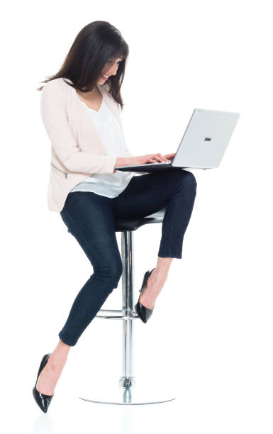 Attractive young businesswoman sitting on stool and working Attractive young businesswoman 11189 stock pictures, royalty-free photos & images