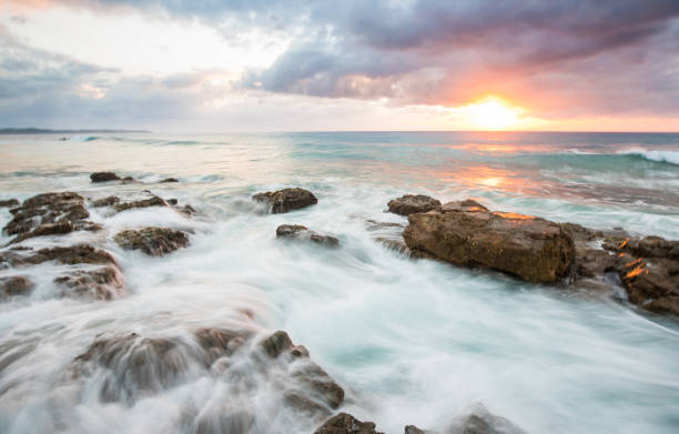 istock Rocky sunrise waves breaking on rocks 928246446