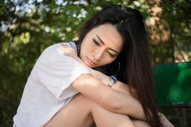 istock Sad loneliness woman sitting on a bench alone at park. 928246558