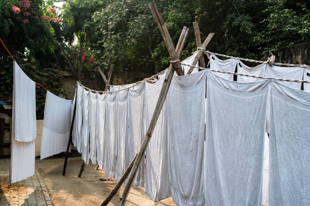 istock White sheets hang on ropes in Indian street 928247214