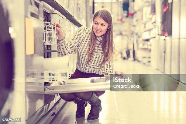 Ordinary Woman Choosing Dishwashing Machine Stock Photo - Download Image Now - Appliance, Retail, Shopping