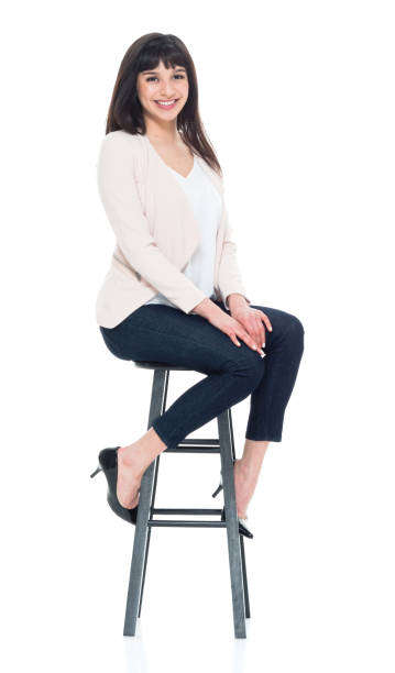 istock Attractive young businesswoman sitting on stool 928248120