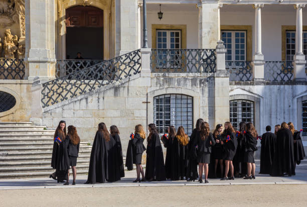 Female students in black dresses at the university of Coimbra, Portugal stock photo