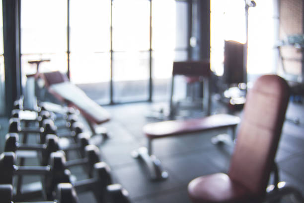 istock Blurred Gym background with equipment for weight training workout 928251514