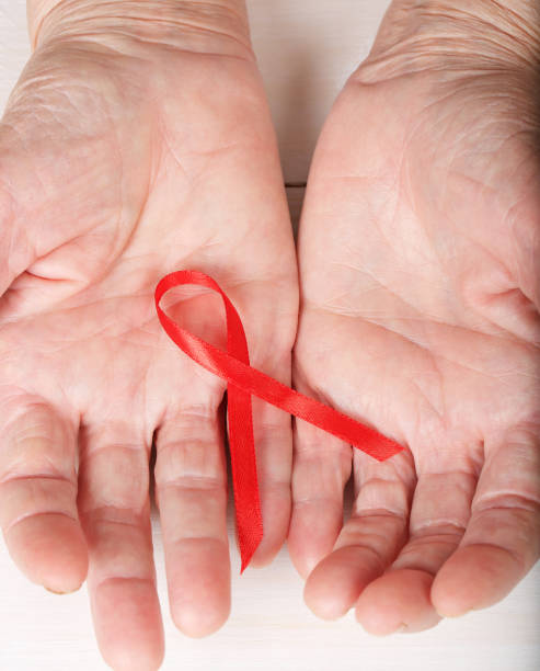 istock Old woman shows red silk ribbon. 928252454