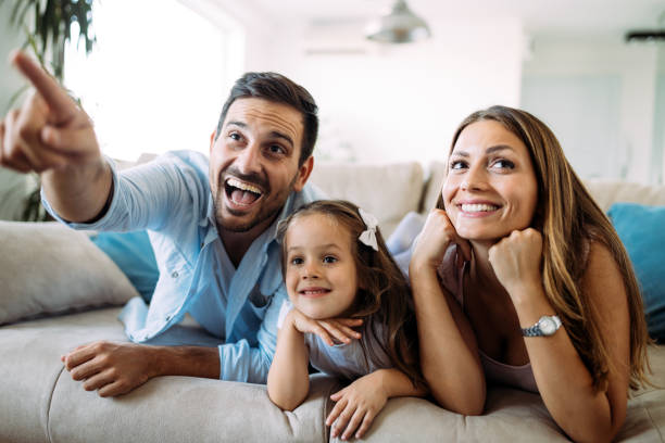 istock Happy family watching television at their home 928254808