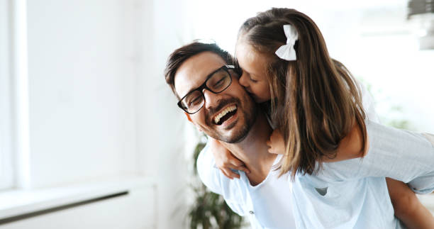 Portrait of father and daughter playing at home Portrait of father and daughter playing at home together daughter stock pictures, royalty-free photos & images