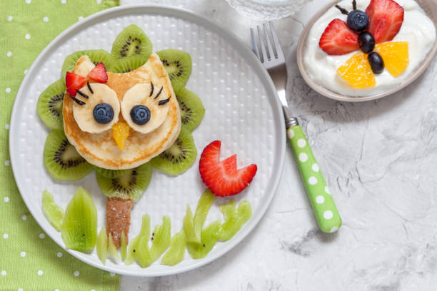 istock Cute owl pancake with fruits for kids breakfast 928261514