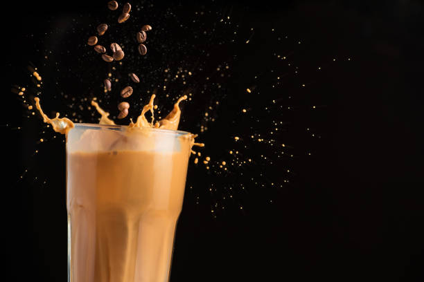 istock Iced latte coffee glass with splash 928272940