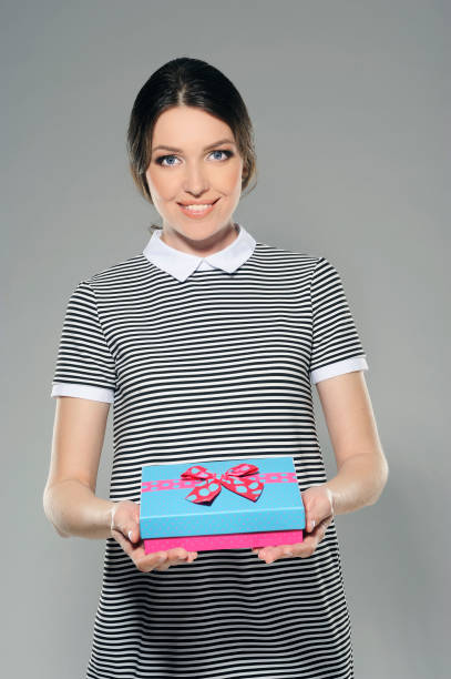 istock Young woman with a present 1. 928272982