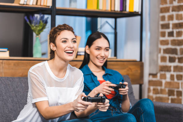 istock beautiful young multiethnic women playing with joysticks together 928275928