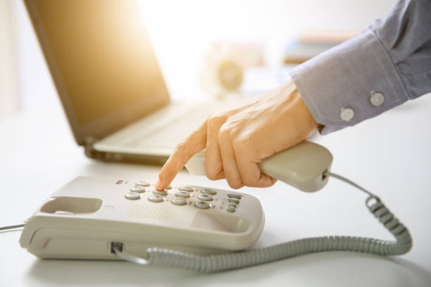 istock businessman dial digital telephone with office background 928276120