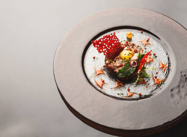 istock Modern restaurant dish. Veal tartare with quail egg closeup 928277162