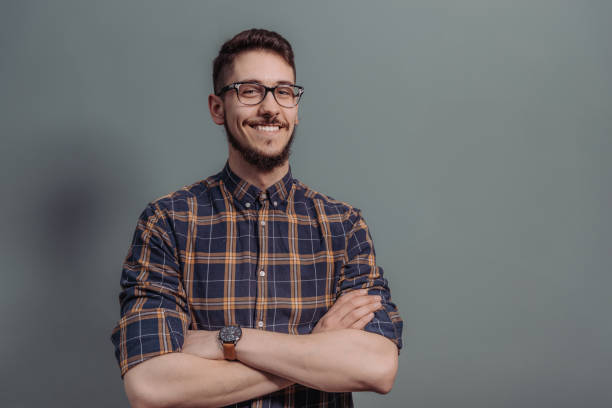 istock Confident man smiling with arms crossed 928280262