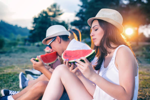istock Friends eating watermelon in nature 928280994