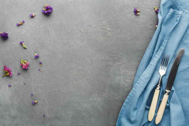 Tablecloth and cutlery on gray table background