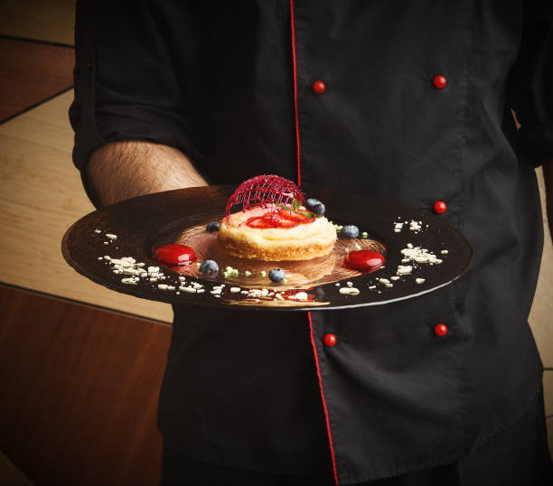 istock Lemon cheesecake with berry spheres served at modern restaurant 928281042