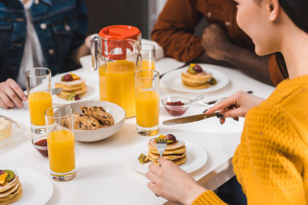istock cropped shot of young people having breakfast together 928281212