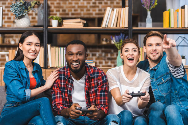 istock excited young multiethnic friends playing with joysticks together at home 928282510